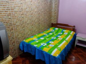 Postel nebo postele na pokoji v ubytování Hostal Yumbo Imperial