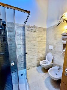 a bathroom with a shower and a toilet and a sink at Casa Roberta in Falcade
