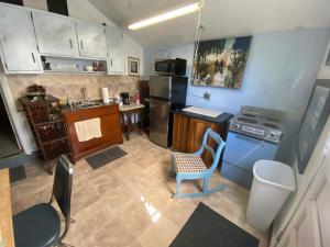 a kitchen with a chair and a sink and a stove at VA Beach Zen retreat house in Virginia Beach