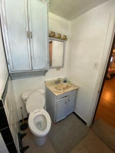 a small bathroom with a toilet and a sink at VA Beach Zen retreat house in Virginia Beach +16 photos