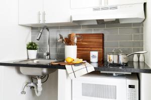 a kitchen counter with a sink and a stove at InTown Suites Extended Stay Select New Orleans LA - Harvey in Harvey