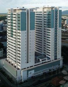 a group of tall white buildings in a city at Flat Apart Hotel América Campos dos Goytacazes in Campos dos Goytacazes