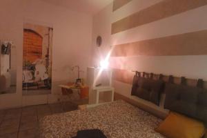a bedroom with a bed and a light on the wall at Vespa house, intima e confortevole in Turin