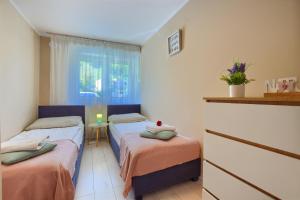 Posteľ alebo postele v izbe v ubytovaní Apartamenty Perła Szczyrku