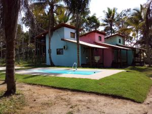 a house with a swimming pool in front of it at Vila Piê in Itacaré