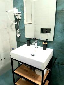 a bathroom with a white sink and a mirror at St Peter Charming House in Rome