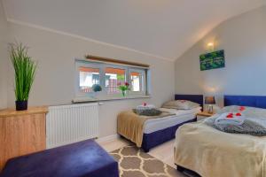 Posteľ alebo postele v izbe v ubytovaní Apartamenty Perła Szczyrku