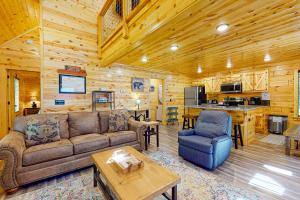 a living room with a couch and a table at Knotty Escape in Gatlinburg