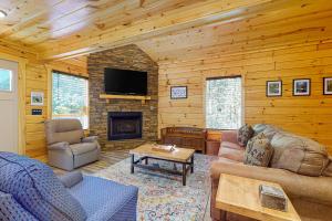a living room with a couch and a fireplace at Knotty Escape in Gatlinburg