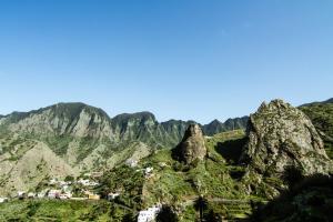 a view of a mountain with a town on it at Apartamentos Los Telares in Hermigua