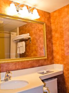 a bathroom with a sink and a mirror at Quality Inn East Stroudsburg - Poconos in East Stroudsburg