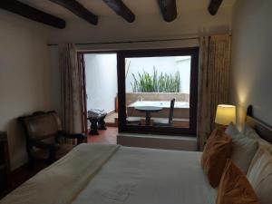Ένα ή περισσότερα κρεβάτια σε δωμάτιο στο Hotel Mesón de los Virreyes