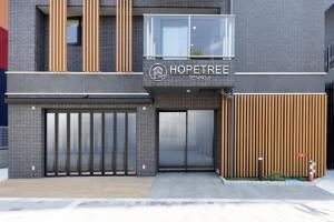 a store with two garage doors on a building at HOPETREE Tennoji in Osaka