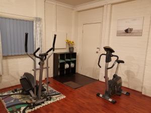 a room with three exercise bikes and a door at Mountain View Beach House in Catalina