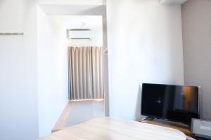 a flat screen tv sitting on a table in a room at The Light Inn - Vacation STAY 94696 in Tokyo