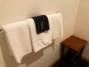 a bathroom with white towels hanging on a wall at Kermandie Hotel in Port Huon