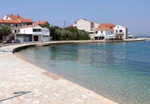 a large body of water with houses and buildings at Apartments Tonci - 30 m from beach in Kali