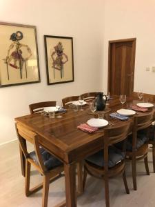 a wooden table with chairs and a dining room at Bukit Indah Boutique Accommodation in Selong Belanak