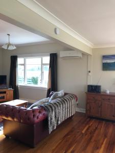 a living room with a couch and a window at Ataahua Homestay in Feilding