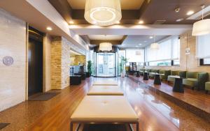 a lobby with a long row of tables and chairs at Hotel Sun White in Osaka