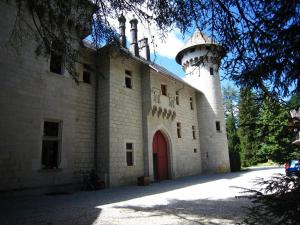 a building with a lighthouse on the top of it at Castle with pool in Serri res en Chautagne in Serrières-en-Chautagne