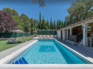 a swimming pool in the backyard of a house at Superb house with pool near the Luberon in Oppède