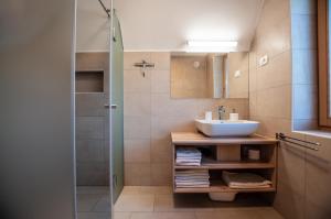 a bathroom with a sink and a shower at Apartments Izvir in Bohinj +20 photos