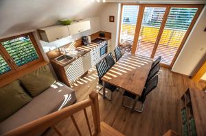 a kitchen and dining area of a tiny house at Apartments Izvir in Bohinj