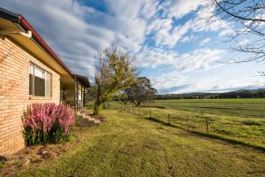 a house with a view of a field at Beaudesert Mudgee - Kanimbla Guesthouse & Beaudesert Cottage in Mudgee