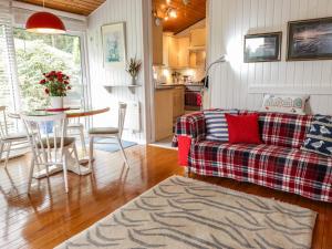 a living room with a couch and a table at Meadow Lodge in Coldingham