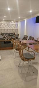 un grupo de mesas y sillas en una habitación en AZURIA HOTEL, en Lomé