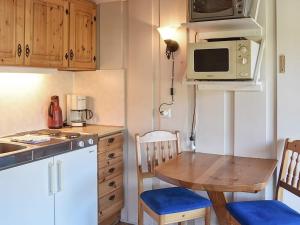 a small kitchen with a table and a microwave at Holiday Home Hytte in Søre Birkedal