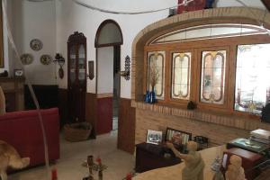 a living room with a fireplace and a red couch at Casa de Pueblo en Navarres in Navarrés