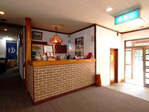 a fast food restaurant with a counter in a room at Pension Kobekko in Otari