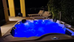 a blue hot tub on a patio at night at Colonno Panoramica Lago Di Como in Colonno