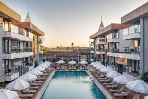 an image of a swimming pool with chairs and umbrellas at Side Amour Hotel in Side