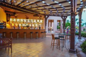 a bar in a resort with chairs and a table at Charmillion Sea Life Resort in Sharm El Sheikh