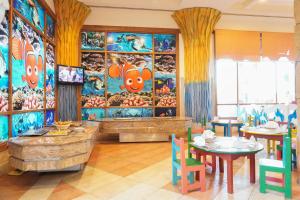 a dining room with tables and chairs and a mural at Charmillion Sea Life Resort in Sharm El Sheikh