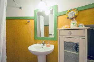 a bathroom with a sink and a mirror at Aloizianika 1768 Traditional GuestHouse in Aloïziánika