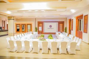 a large banquet hall with white tables and white chairs at Charmillion Sea Life Resort in Sharm El Sheikh