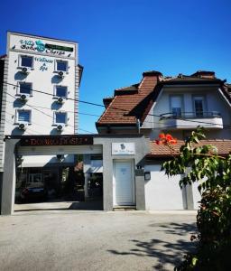 a building with a parking garage in front of it at Villa Boho Cherga in Belgrade