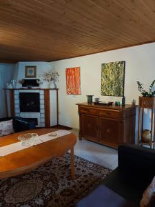 a living room with a table and a fireplace at Im kurfürstlichen Zollamt in Tangermünde