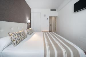 A bed or beds in a room at Hotel Matilde by Grupo Matilde