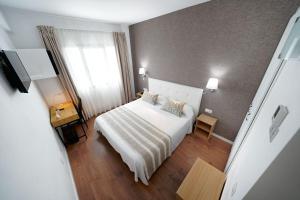 A bed or beds in a room at Hotel Matilde by Grupo Matilde