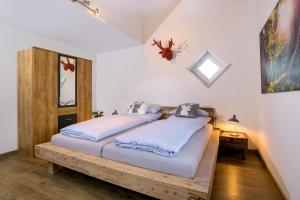 two beds in a room with white walls at BergFux Ferienhaus - hochwertige Ausstattung in Sonthofen