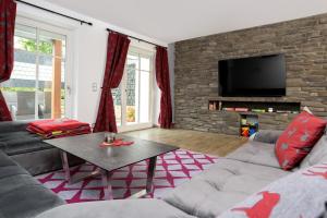 a living room with a couch and a table at BergFux Ferienhaus - hochwertige Ausstattung in Sonthofen