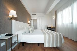 A bed or beds in a room at Hotel Matilde by Grupo Matilde