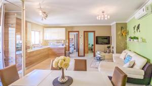 a living room with a couch and a table at Holiday Hub Gozo - 3 Bedrooms in Xewkija