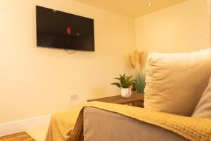 a living room with a tv on the wall at Stylish City Apartment - Prime Location! in Nottingham