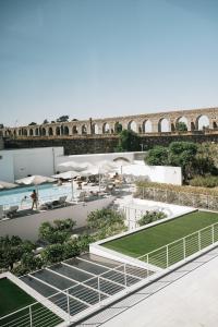 a view of a building with a pool and a bridge at M'AR De AR Aqueduto in Évora